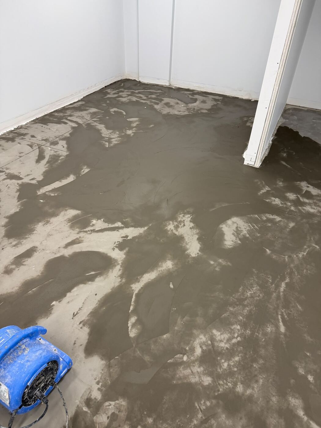 Self-leveling underlayment being applied to subfloor