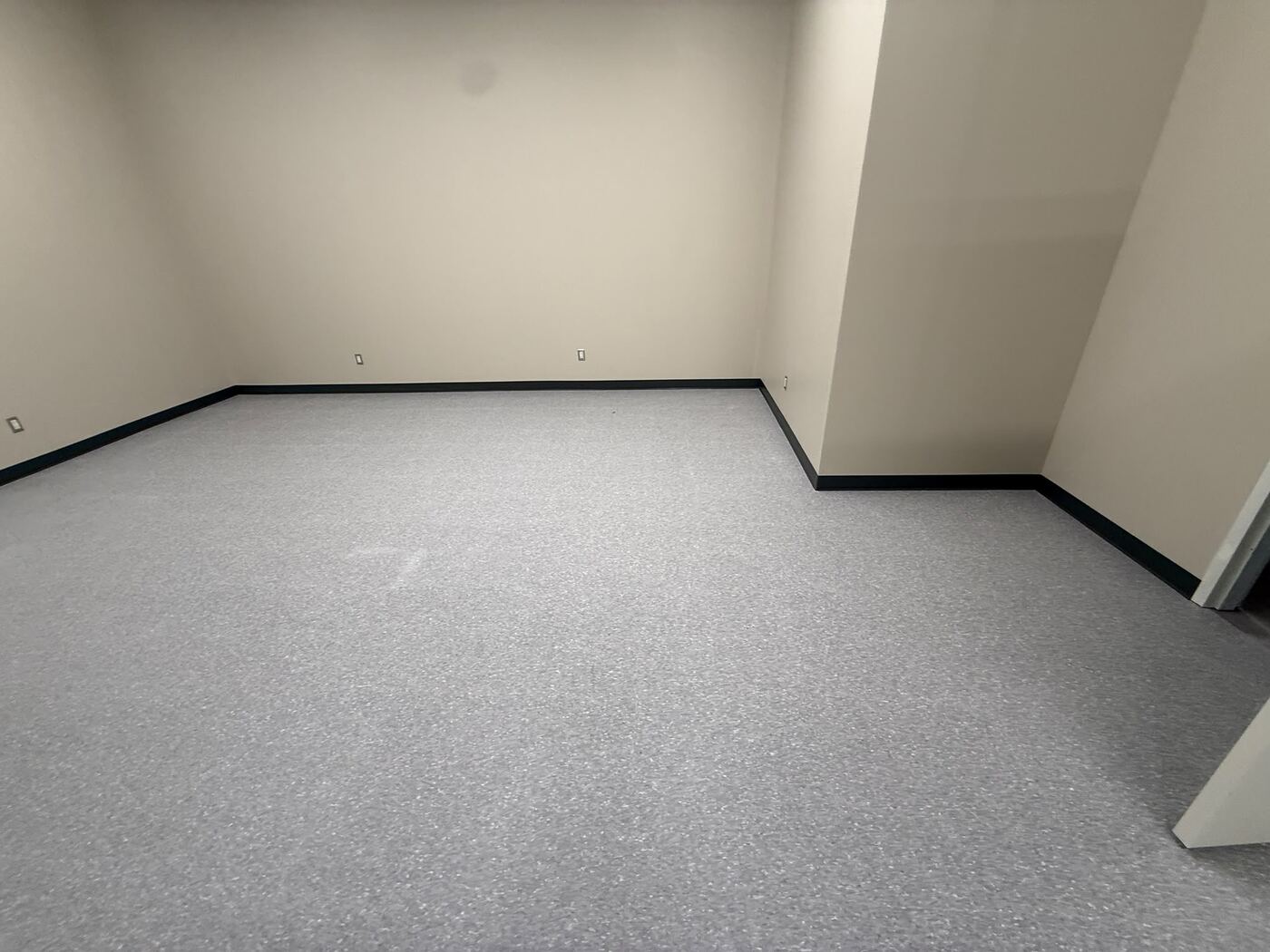 Finished sheet vinyl flooring with cove base in a commercial space